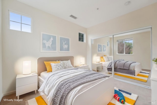 bedroom featuring visible vents and baseboards