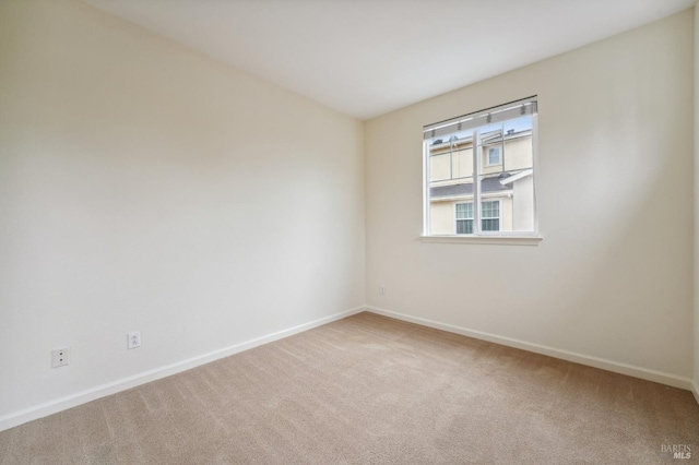 unfurnished room featuring carpet flooring and baseboards