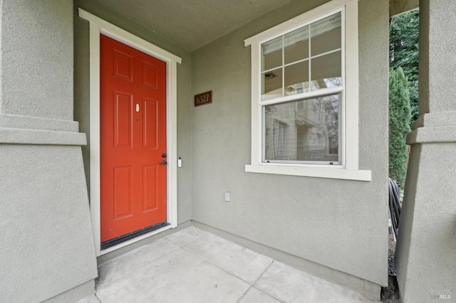 doorway to property with stucco siding