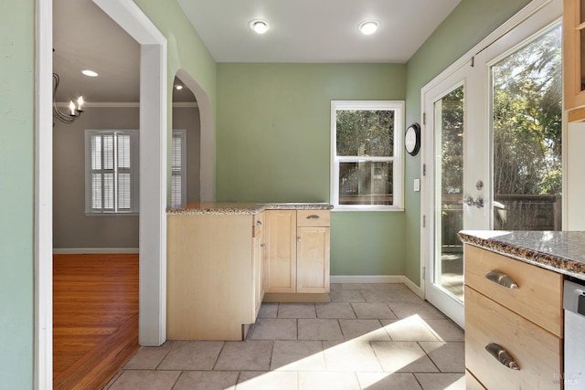 kitchen featuring plenty of natural light, baseboards, and light brown cabinetry