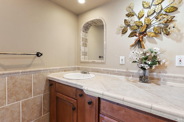 bathroom featuring recessed lighting, wainscoting, vanity, and tile walls