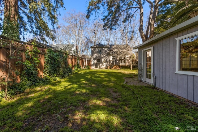 view of yard featuring an outdoor structure and a fenced backyard