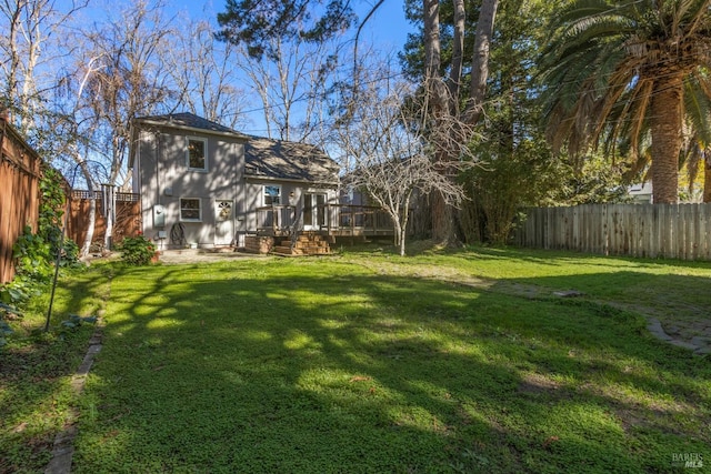 view of yard with a fenced backyard and a deck