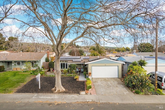 ranch-style home with driveway, solar panels, a residential view, an attached garage, and a front lawn