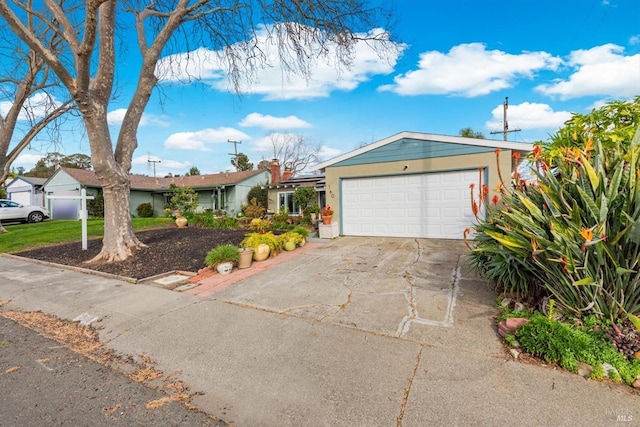 ranch-style home featuring an attached garage and concrete driveway