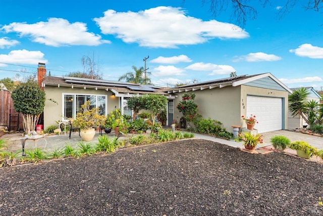 ranch-style house with driveway, a chimney, fence, and stucco siding