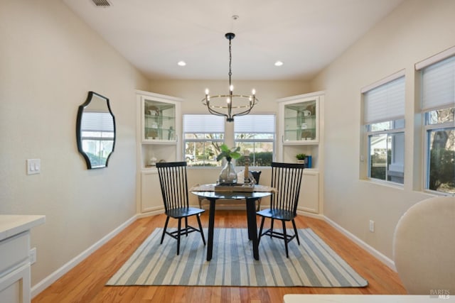 dining area featuring a chandelier, recessed lighting, light wood-style flooring, and baseboards