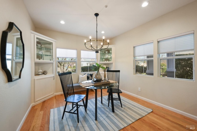 dining space with a chandelier, light wood finished floors, recessed lighting, and baseboards