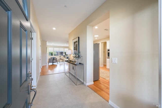 entryway featuring baseboards and recessed lighting