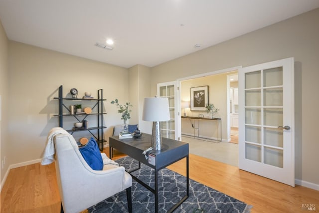 office area featuring french doors, visible vents, baseboards, and wood finished floors
