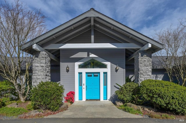 view of exterior entry featuring stone siding