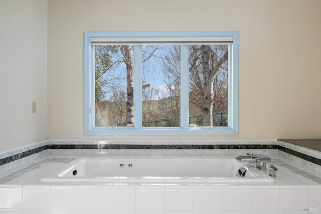 full bath featuring a bath and a wealth of natural light