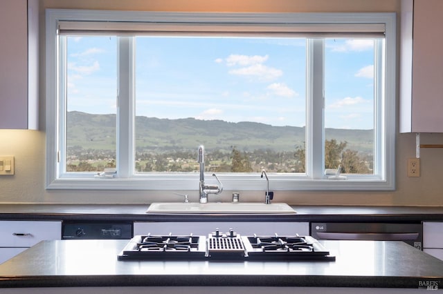 kitchen with stovetop with downdraft and dark countertops