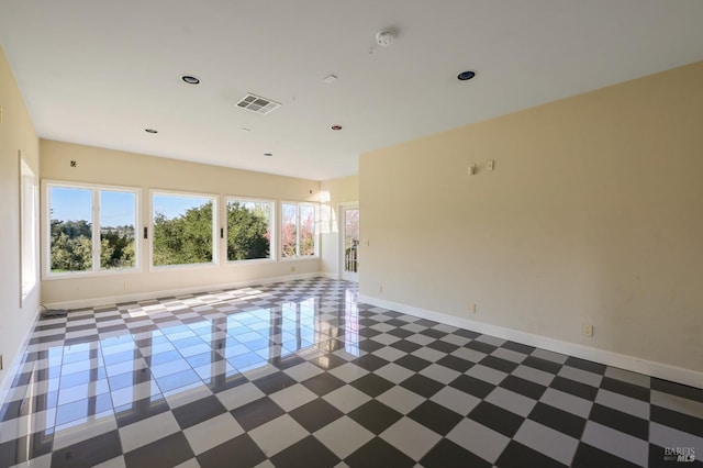 empty room featuring baseboards and visible vents