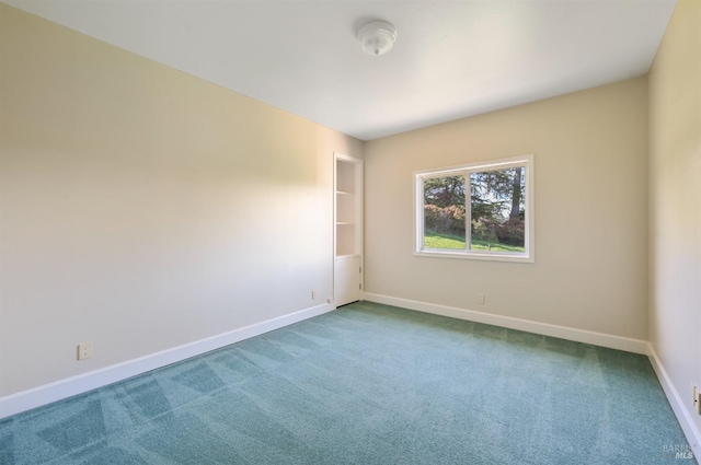 empty room with carpet floors and baseboards