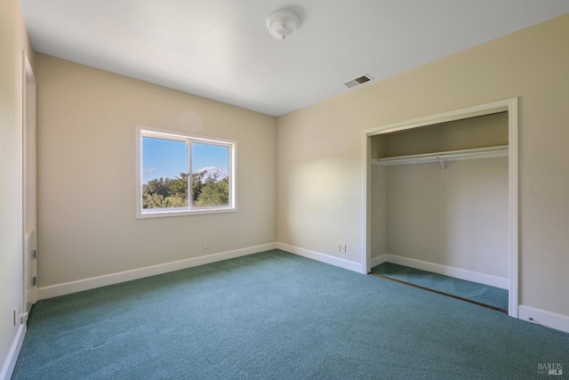 unfurnished bedroom with carpet floors, a closet, visible vents, and baseboards