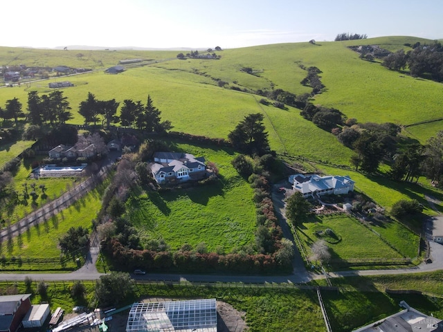 birds eye view of property with a rural view