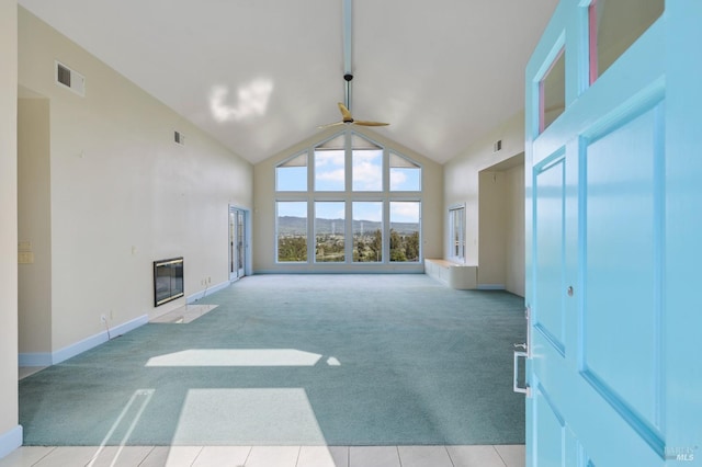 unfurnished living room featuring light carpet, high vaulted ceiling, a fireplace with flush hearth, and visible vents