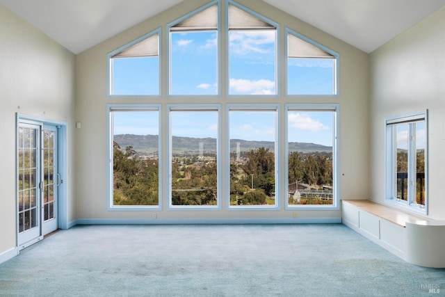 interior space featuring vaulted ceiling and a mountain view