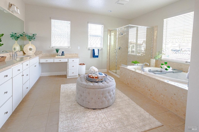 bathroom with a healthy amount of sunlight, a bath, a shower stall, and tile patterned flooring