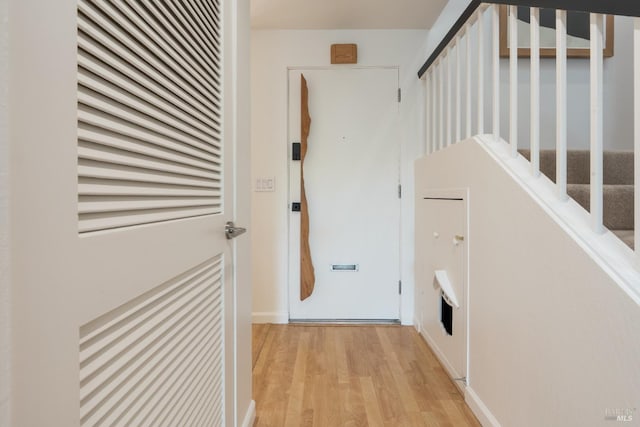 hallway featuring stairway and light wood-type flooring