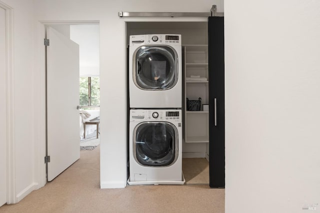 laundry area with stacked washer and dryer, laundry area, and carpet flooring