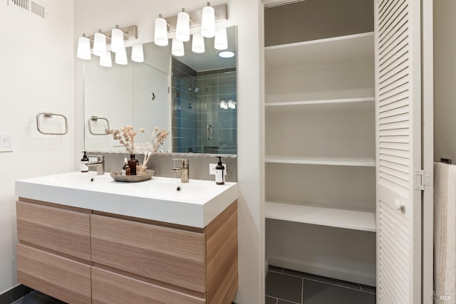 bathroom with a closet, visible vents, a shower stall, and tile patterned floors