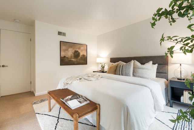 bedroom with light carpet and visible vents