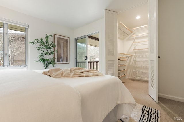 bedroom featuring light carpet, access to outside, multiple windows, and baseboards