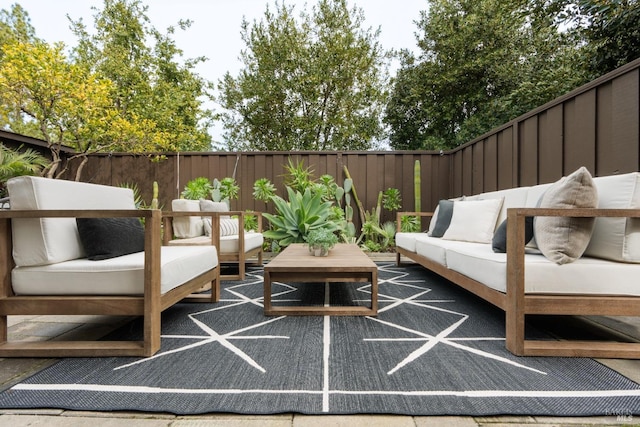 view of patio featuring outdoor lounge area and a fenced backyard