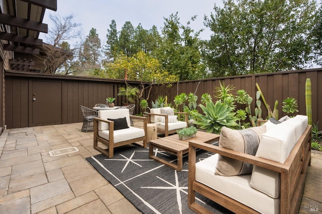 view of patio featuring outdoor dining area, outdoor lounge area, and a fenced backyard