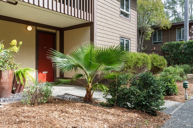 view of property exterior featuring a balcony and stucco siding