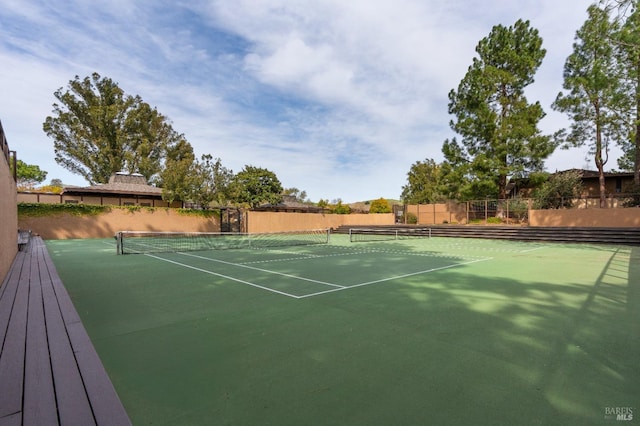 view of tennis court with fence