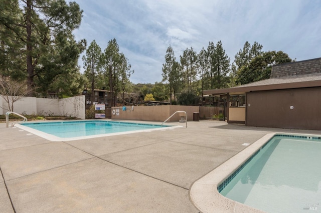 pool featuring a patio area and fence