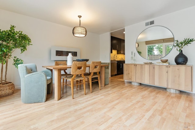 dining room with visible vents and light wood finished floors