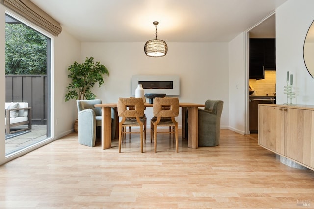 dining room featuring light wood-style floors and baseboards