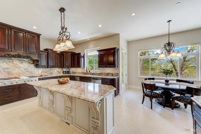kitchen featuring a kitchen island, light stone countertops, decorative backsplash, an inviting chandelier, and stainless steel appliances