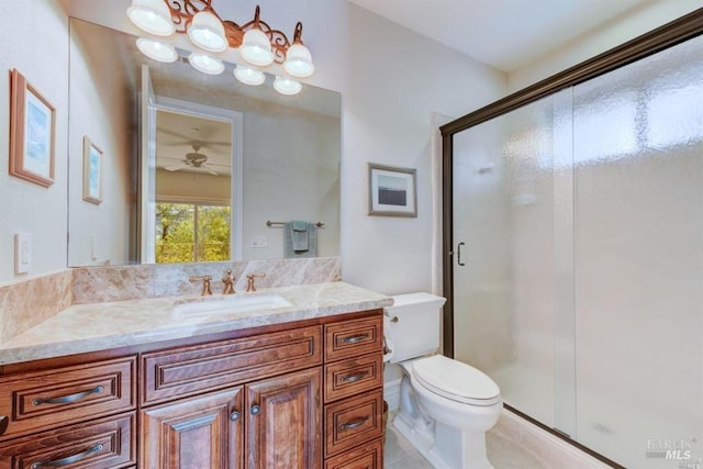 full bath with vanity, a stall shower, ceiling fan, tile patterned flooring, and toilet