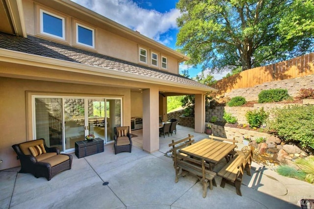 view of patio featuring outdoor dining area and fence