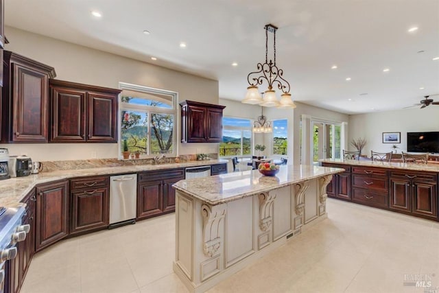 kitchen featuring light stone countertops, a sink, stainless steel dishwasher, range, and a center island