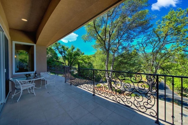 view of patio featuring a balcony