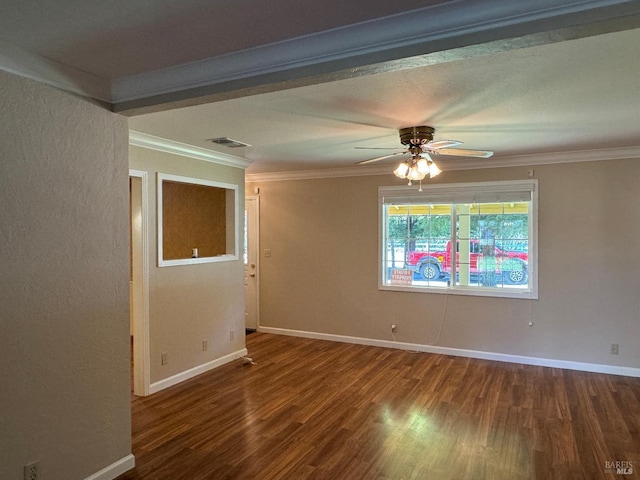 unfurnished room with baseboards, visible vents, wood finished floors, and ornamental molding