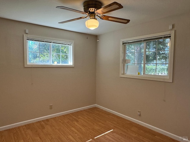 unfurnished room with light wood-style flooring, baseboards, and ceiling fan