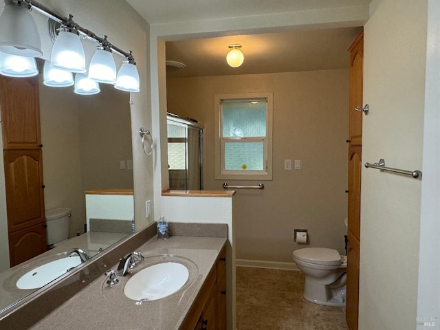 full bath with toilet, a shower stall, baseboards, and vanity