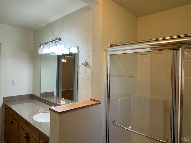 bathroom with a stall shower and vanity