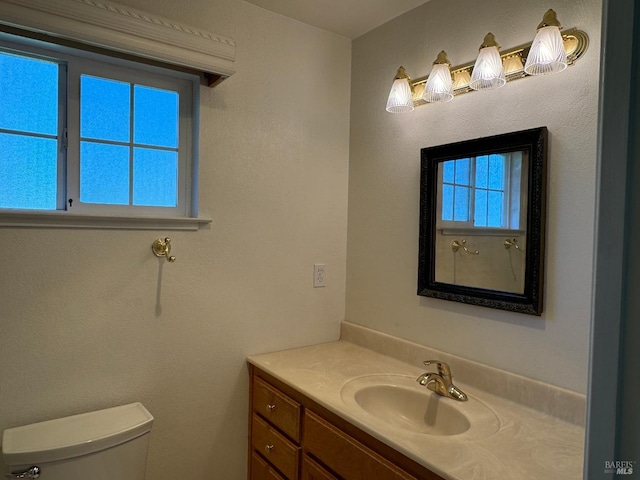 bathroom featuring vanity and toilet