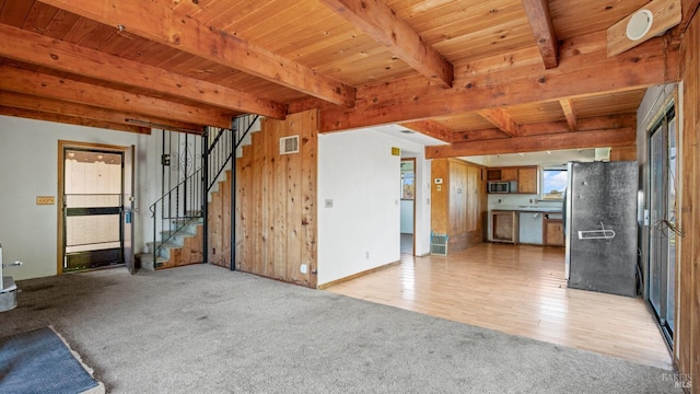 interior space with stairs, beam ceiling, wood ceiling, and visible vents