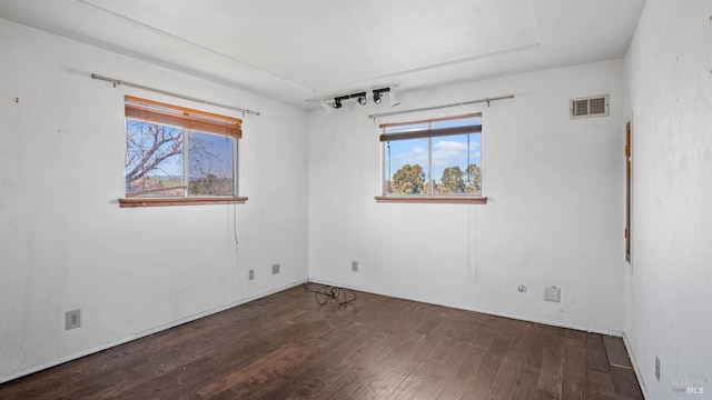 spare room with visible vents and hardwood / wood-style floors