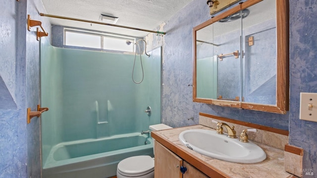 full bathroom with vanity, toilet, bathtub / shower combination, and a textured ceiling