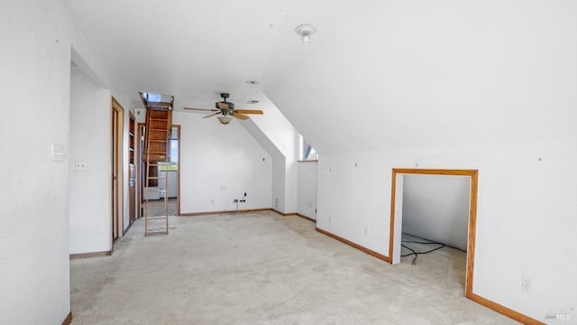 bonus room with baseboards, lofted ceiling, a ceiling fan, and carpet flooring